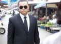 Bodyguard ensuring safety in bustling Tây Ninh market.